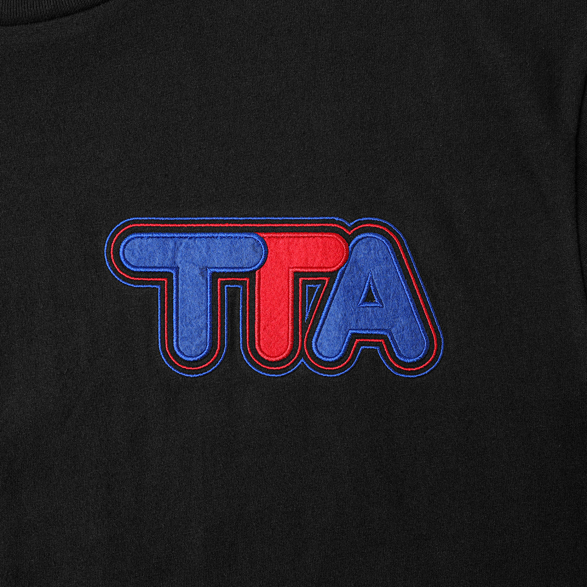Close up of Turbo Threads Black Box Fit Tee with blue and red turbo threads logo