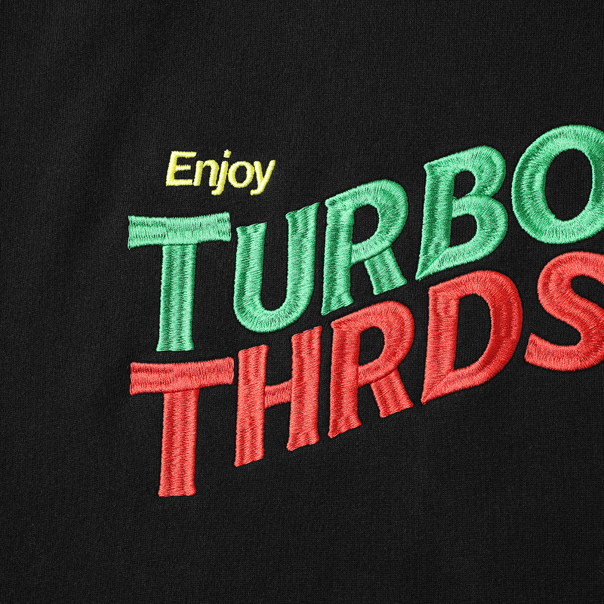 Close up image of Turbo Threads Black Box Fit Hoodie with yellow, green & red Turbo Threads Days Of Thunder inspired logo.