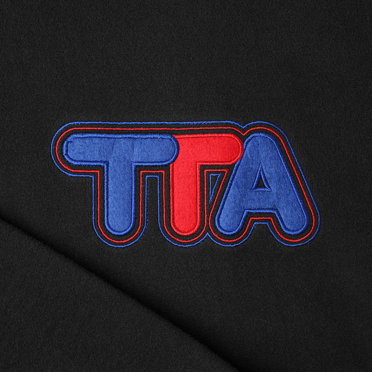Close up of Turbo Threads Black Box Fit Hoodie with blue and red turbo threads logo