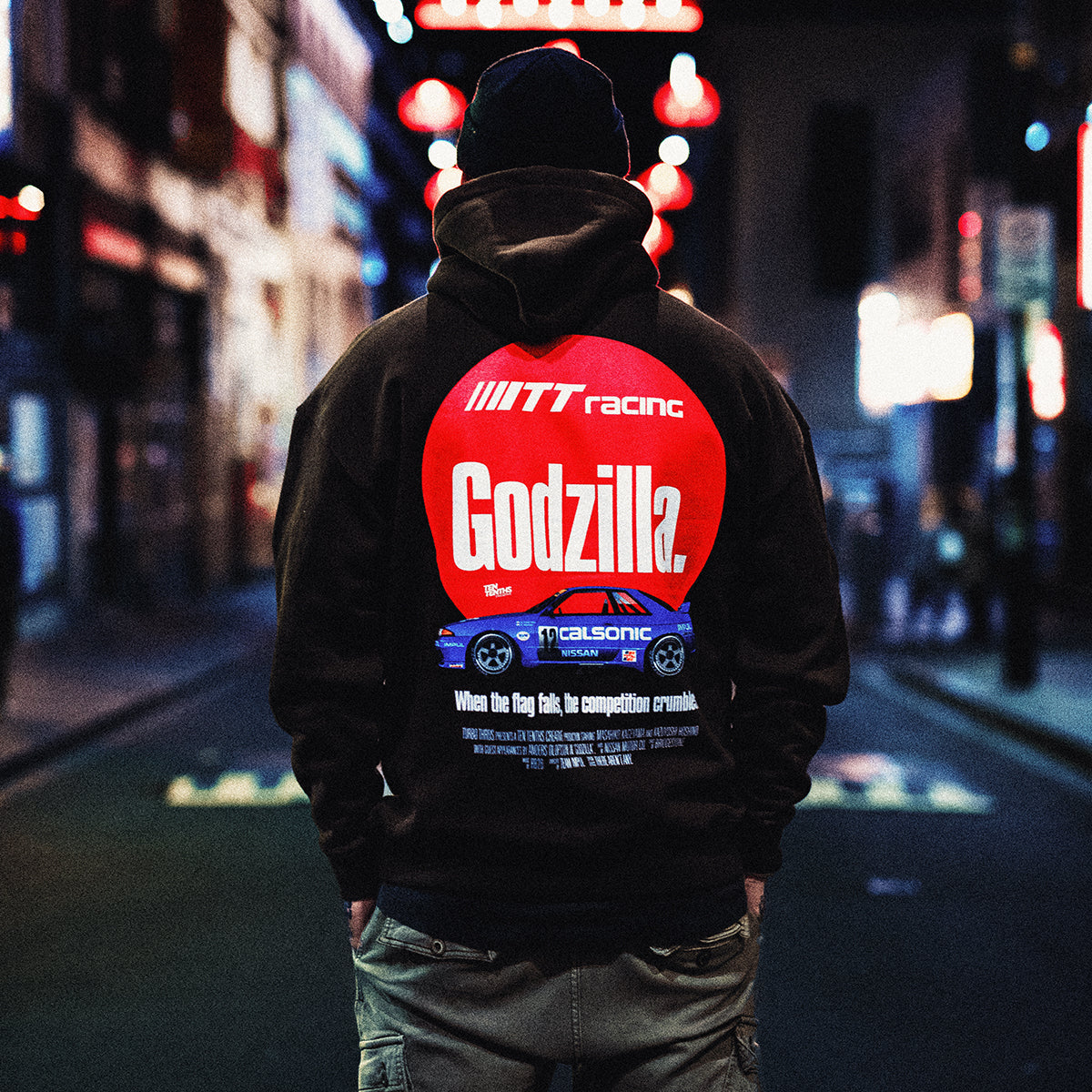 Man wearing Dark brown graphic hoodie featuring the Calsonic R32 GT-R car